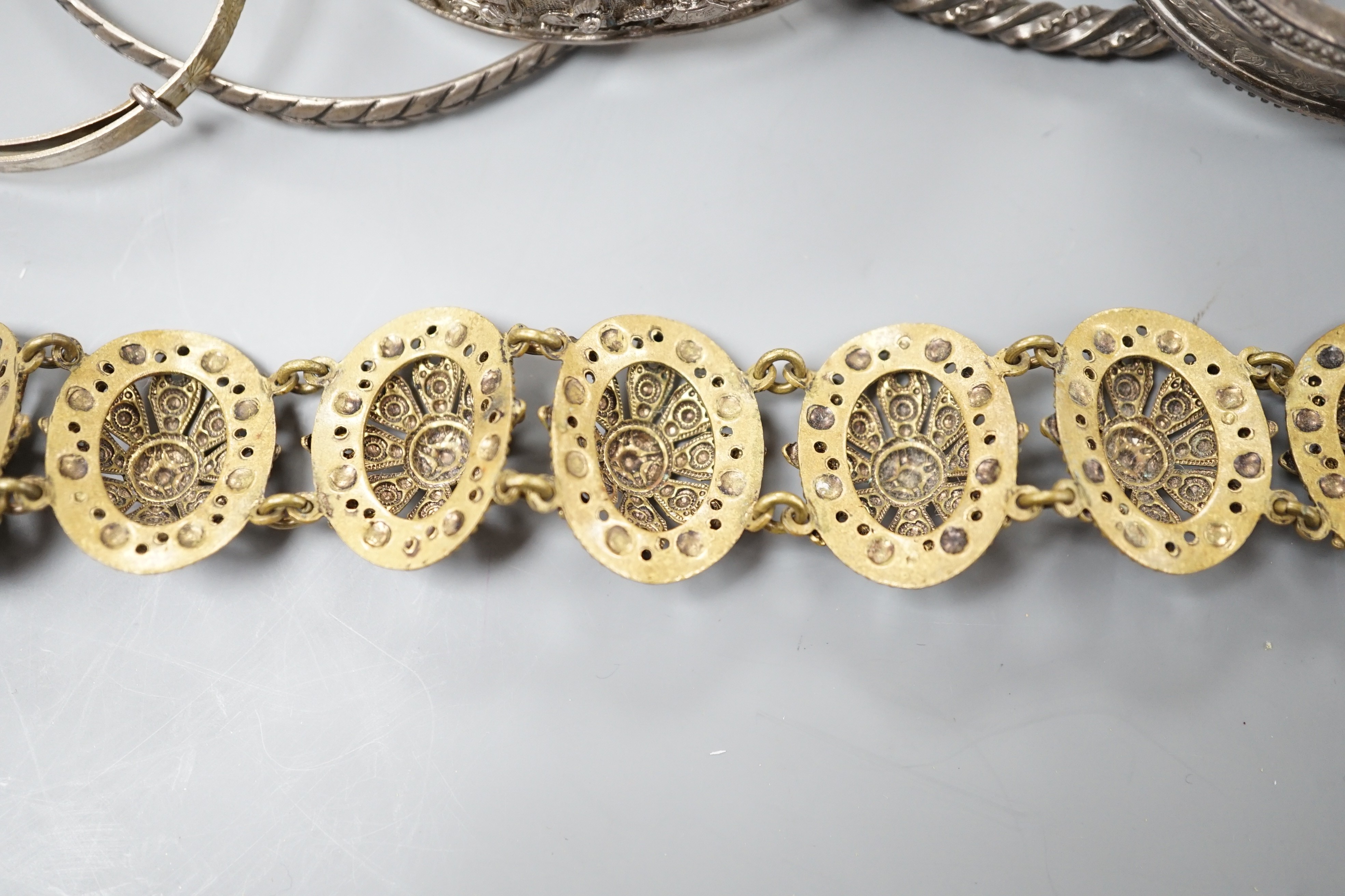 A Chinese white metal hinged bangle and five other items, including an engraved silver hinged bangle.
